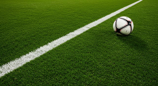 Soccer ball on a lush green field near the white sideline. photo