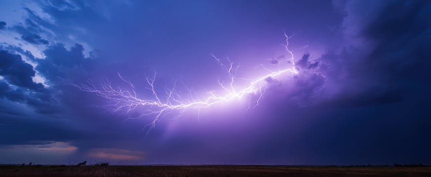 The dramatic lightning bolt illuminating a stormy purple sky. photo