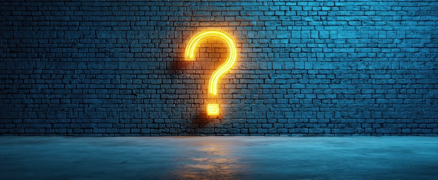 The Bright Neon Question Mark Illuminating a Blue Brick Wall Background photo