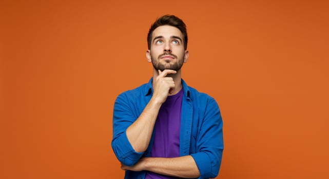 Thoughtful Man Contemplates on Orange Background photo