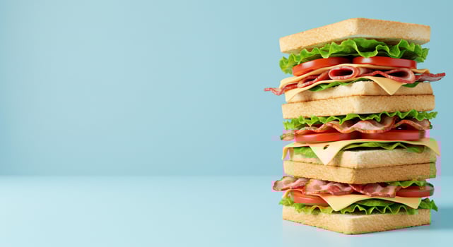 Towering Bacon, Lettuce, and Tomato Sandwich on Blue photo