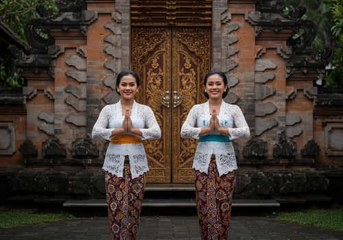 Two women greet at temple entrance. Cultural welcome. Tourism industry shot photo