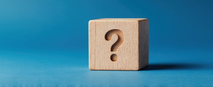 The Wooden Block with a Question Mark on a Blue Background photo
