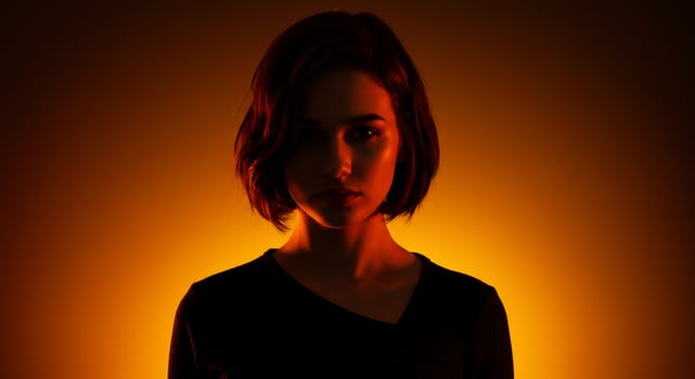 A woman in black shirt and orange light photo