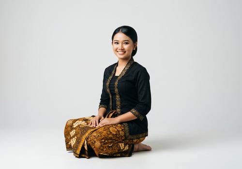 Woman kneeling, wearing a traditional dress, studio shot, looking to the camera photo