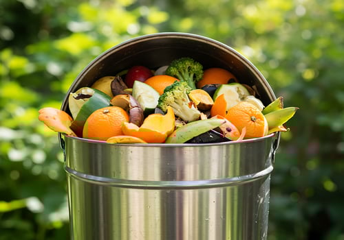A metal can with fruit and vegetables in it photo