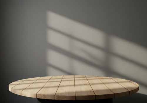 Wooden platform on sunlit gray background for product mockup. Lifestyle usage photo