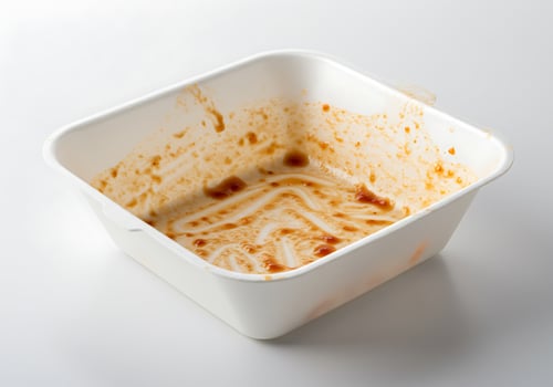 A white container with a lot of sauce in it photo