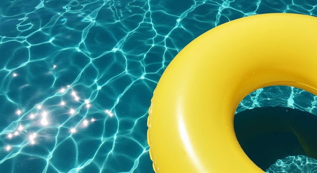 An inflatable yellow life ring floating in a pool photo