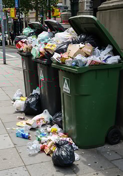 A garbage can on the sidewalk photo