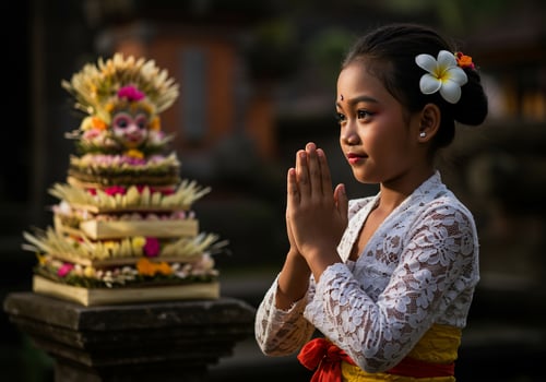 Young girl praying at temple in Bali ceremony with offerings in background photo