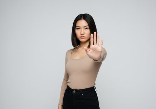 Young Woman Gesturing Stop in Studio with Neutral Background for Rejection Concept photo