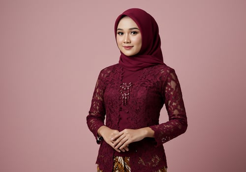 Young woman in traditional dress smiles against pink, cultural fashion background photo
