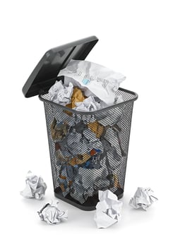 A trash can filled with crumpled paper and a lid photo