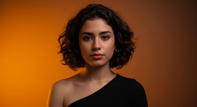 Young woman with curly hair on orange background photo