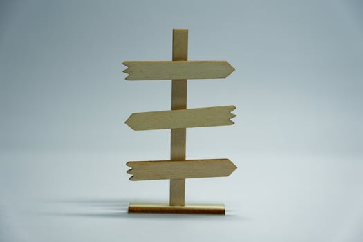 Front view of wooden direction sign on neutral white background photo