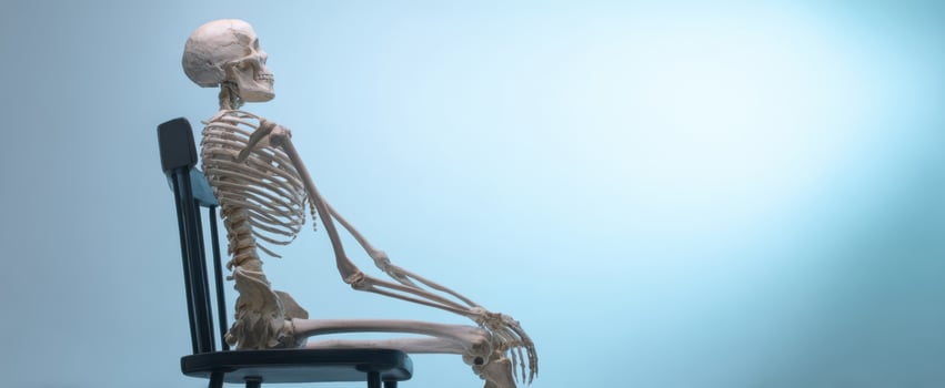 The Skeleton Sitting Calmly on a Chair Against a Soft Background photo