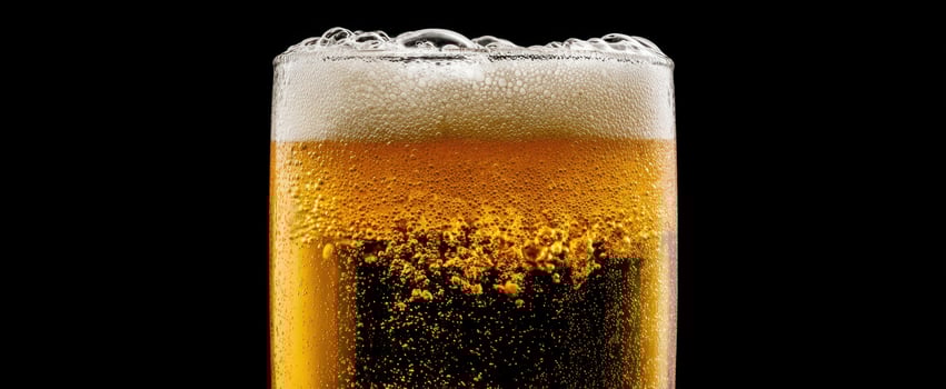 The refreshing golden beer in a frosty glass with bubbles. photo