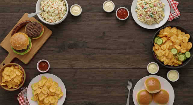BBQ foods on dark wood background. Burgers, sausages, salad and chips. Party time photo