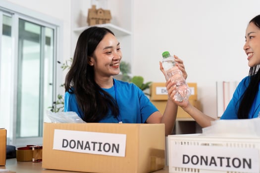 Volunteers sharing donations at charity center, teamwork and joy photo