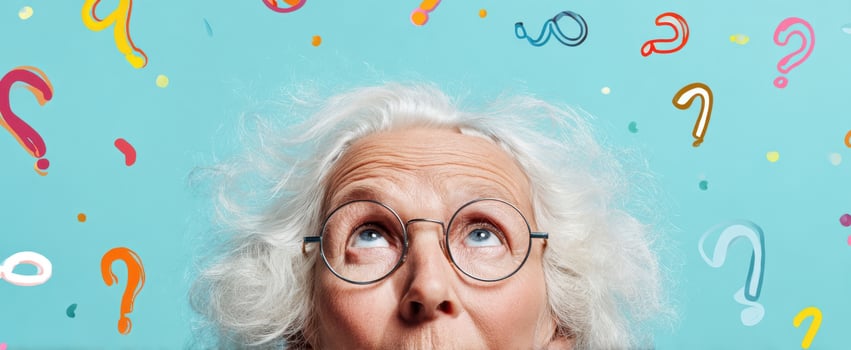 The elderly woman contemplating questions with a curious expression against a colorful backdrop. photo