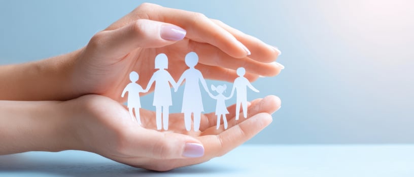 The protective hands surrounding a symbolic family cutout illustration. photo