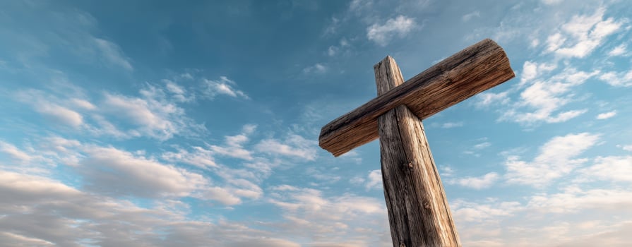 The Rustic Wooden Cross Against a Beautiful Sky and Clouds photo