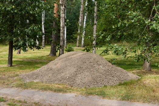 A Natural Pile of Gravel Beautifully Placed in a Peaceful Park Setting Surrounded by Nature photo