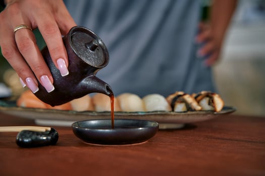 A Culinary Experience Featuring Handcrafted Sushi Delicacies Served with Soy Sauce and Accompanied by Traditional Japanese Elements photo