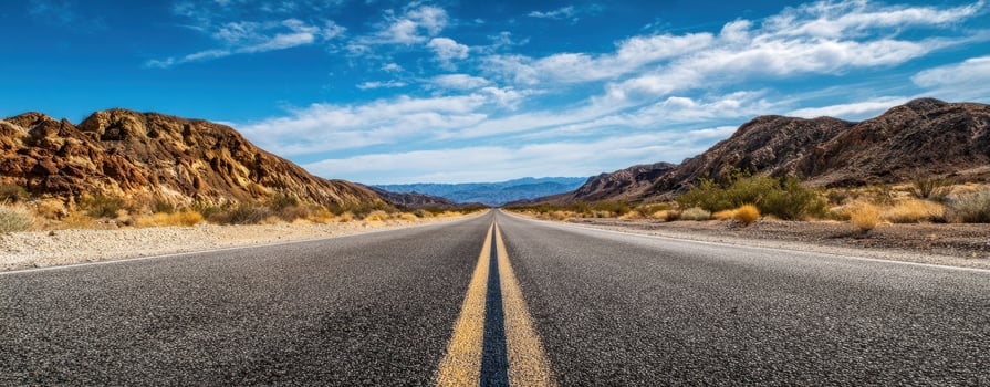 The winding road through the breathtaking desert landscape under a clear blue sky. photo