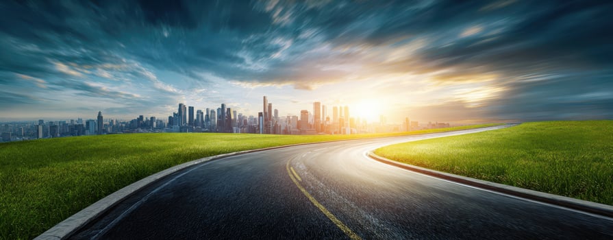 The winding road leading to a vibrant city skyline at sunrise. photo