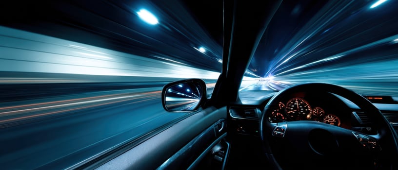 The dynamic interior of a speeding car in a vibrant illuminated tunnel. photo