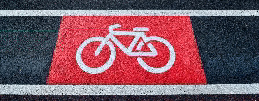 The bicycle symbol marking on a vibrant red bike lane pavement. photo