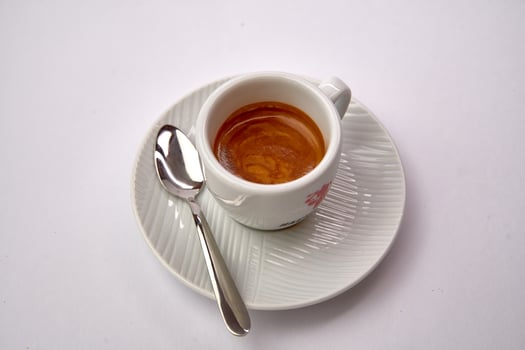Rich, Aromatic Espresso Served in a Traditional White Cup with a Silver Spoon, Perfect for Coffee Lovers Seeking a Bold Experience photo