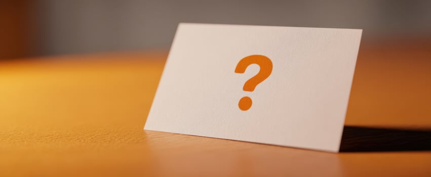 The card featuring a prominent question mark on a sleek wooden surface photo