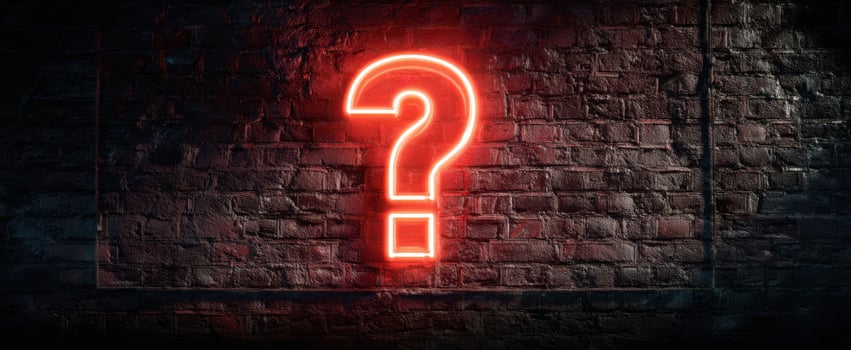 The Neon Question Mark Illuminating a Dark Brick Wall Background photo