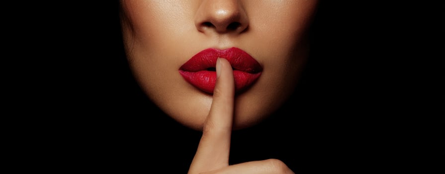 The Mysterious Beauty with Red Lips and a Silent Gesture photo