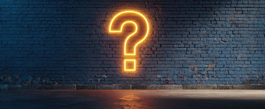 The glowing neon question mark on a textured blue brick wall photo