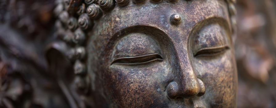 The Serene Face of a Bronze Buddha Sculpture Reflecting Tranquility and Wisdom photo