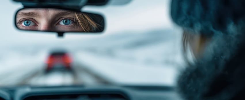 The mesmerizing reflection of a woman's eyes in a winter car mirror. photo