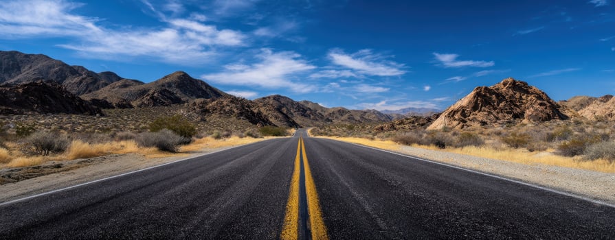 The open road stretching through a picturesque desert landscape under a bright sky. photo