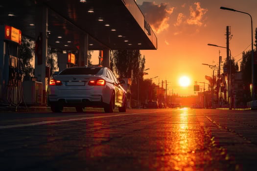 A car is parked at a gas station at sunset photo