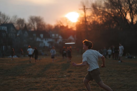 A man running in a field with a frisbee photo