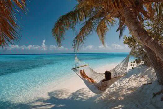 Woman relaxing in hammock on tropical beach photo