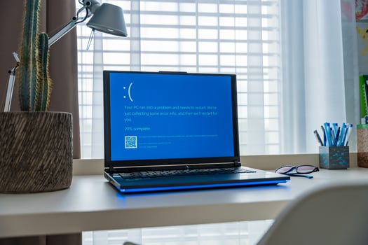 Prague, Czech Republic - September 11, 2024. Blue screen of death on a laptop at home office, day photo