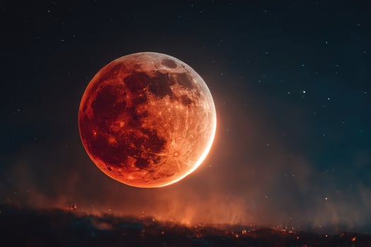The moon is seen in the sky with a red glow photo