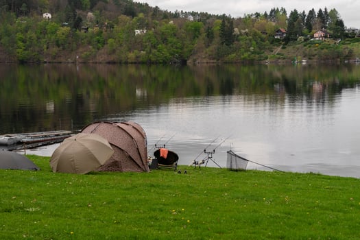 Fishing tents and rods on riverbank at Nova Zivohost, Czech Republic in spring photo