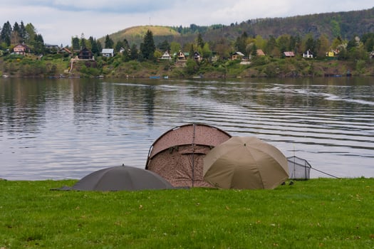 Fishing tents and rods on riverbank at Nova Zivohost photo