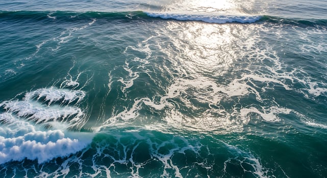 Overhead view of ocean water with sunlight creating a shimmering effect photo