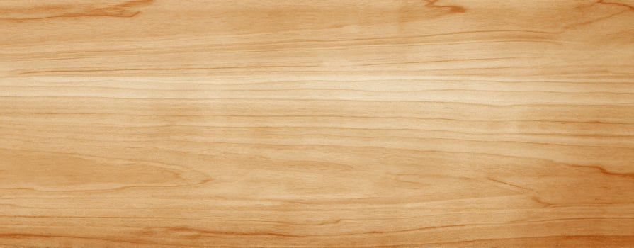 The smooth wooden surface with natural grain patterns and warm tones. photo